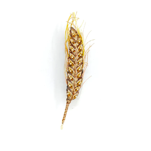 A BROOCH DESIGNED TO LOOK LIKE AN EAR OF WHATE. BEAD AND THREAD DETAIL ARE INTRICATELY DONE. 