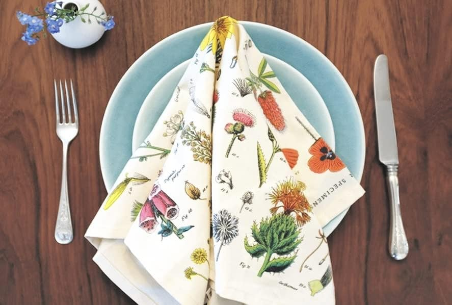 Wildflower tea towel folded neatly on top of two blue plates. 