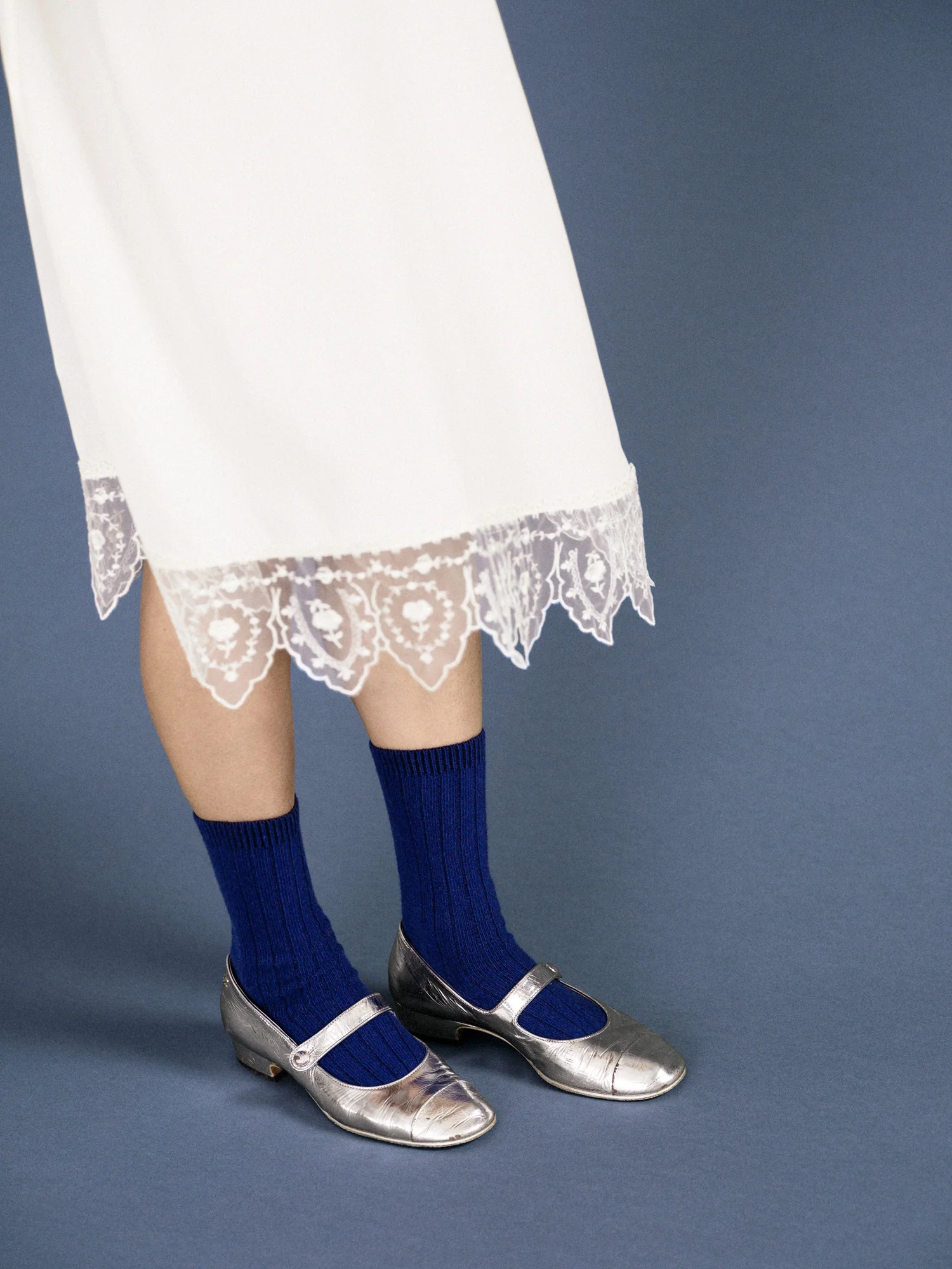 blue socks pair with a fun skirt and metallic silver shoes. 