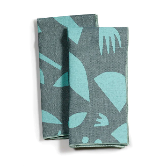 Set of two napkins folded long ways. The print has a bright blue geometric print thats contrasted by a darker blue color. 