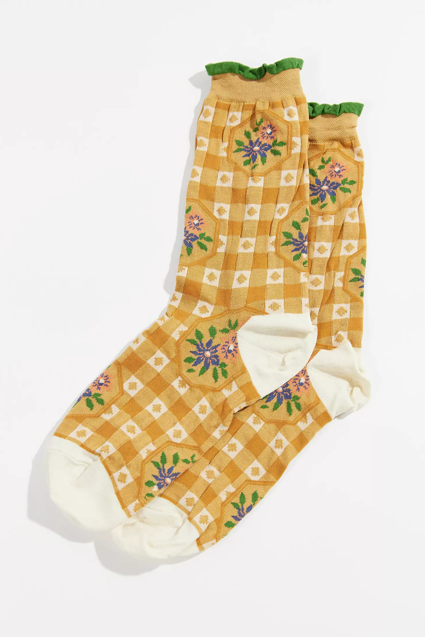 pair of socks with yellow and white plaid, white toes and a green ankle trim. 
