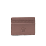 Small ash pink wallet displayed in front of a whote background. Embossed logo sits in the center of the wallet.