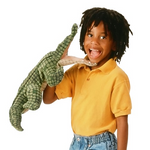 young child holding the alligator hand puppet. Alligator has and oepn mouth and the child has big open mouth smile. 