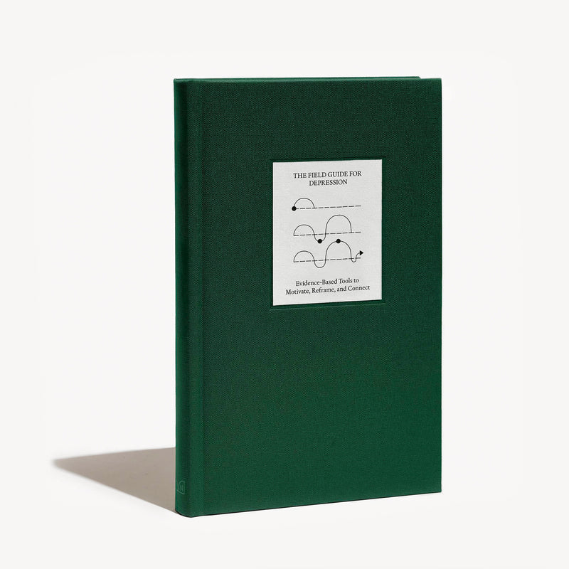 green journal with white sticker displayed on front. Journal standing at a slight angle agaiants a white background.