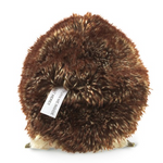 back side of small brown hedgehog. White tag visible that reads "turn me inside out here!". 