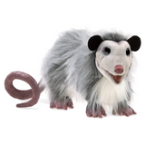 opossum puppet looking straight ahead with mouth ajar, big eyes, and a curly tail. 