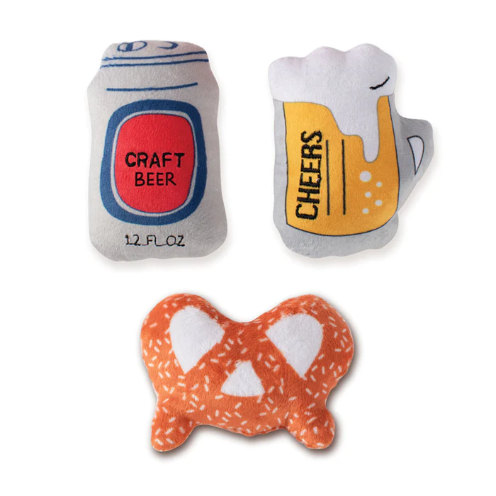 3 small dog toys that look like a beer can, a pretzel and a glass of beer. 