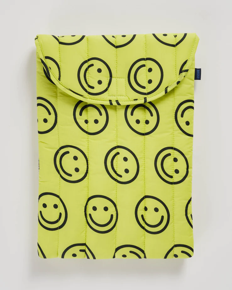 yellow laptop case with smiley face print. 