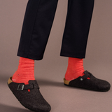 image shows a person wearing dark pants and shoes with the socks providing a nice contrast 
