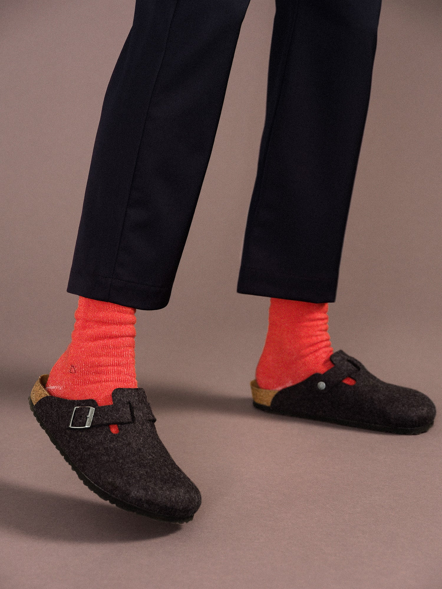 image shows a person wearing dark pants and shoes with the socks providing a nice contrast 