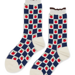 pair of socks with a checkered pattern. Inside the white squares are small individual tomatoes. 