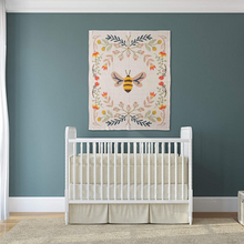 Load image into Gallery viewer, Bee Cotton Knit Baby Blanket on Wall in Nursery
