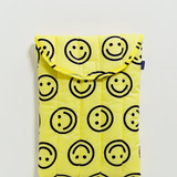 bright yellow laptop case with simple smiley faces. In front of white background. 