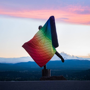 Rainbow Fade Original Puffy Blanket on Model in Sunset